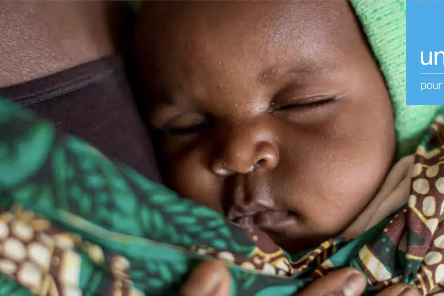 an infant sleeps on her mom's chest