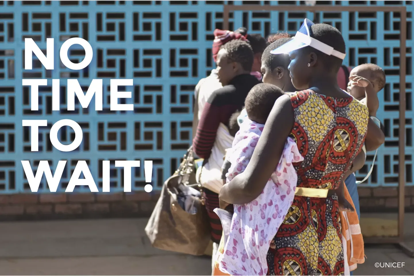 Three moms with babies in line outside a clinic