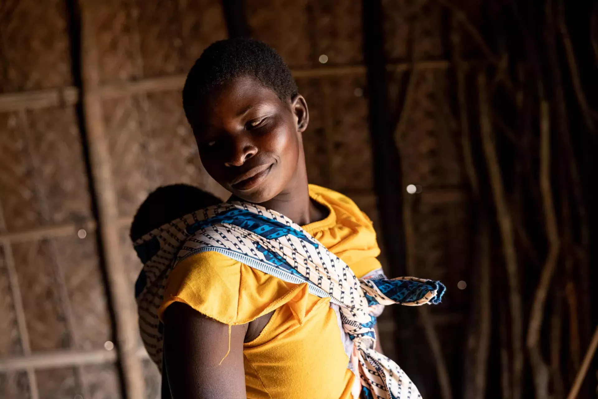 A mother and her children are beneficiaries of regular home visits from N'weti Mentor Mother Luisa in their home in the remote area of Panga, Mozambique 